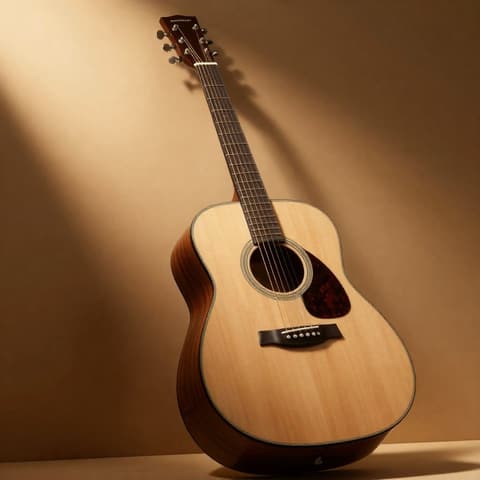 Musical instruments: natural wood folk guitar leaning against a wall in warm light and shadow